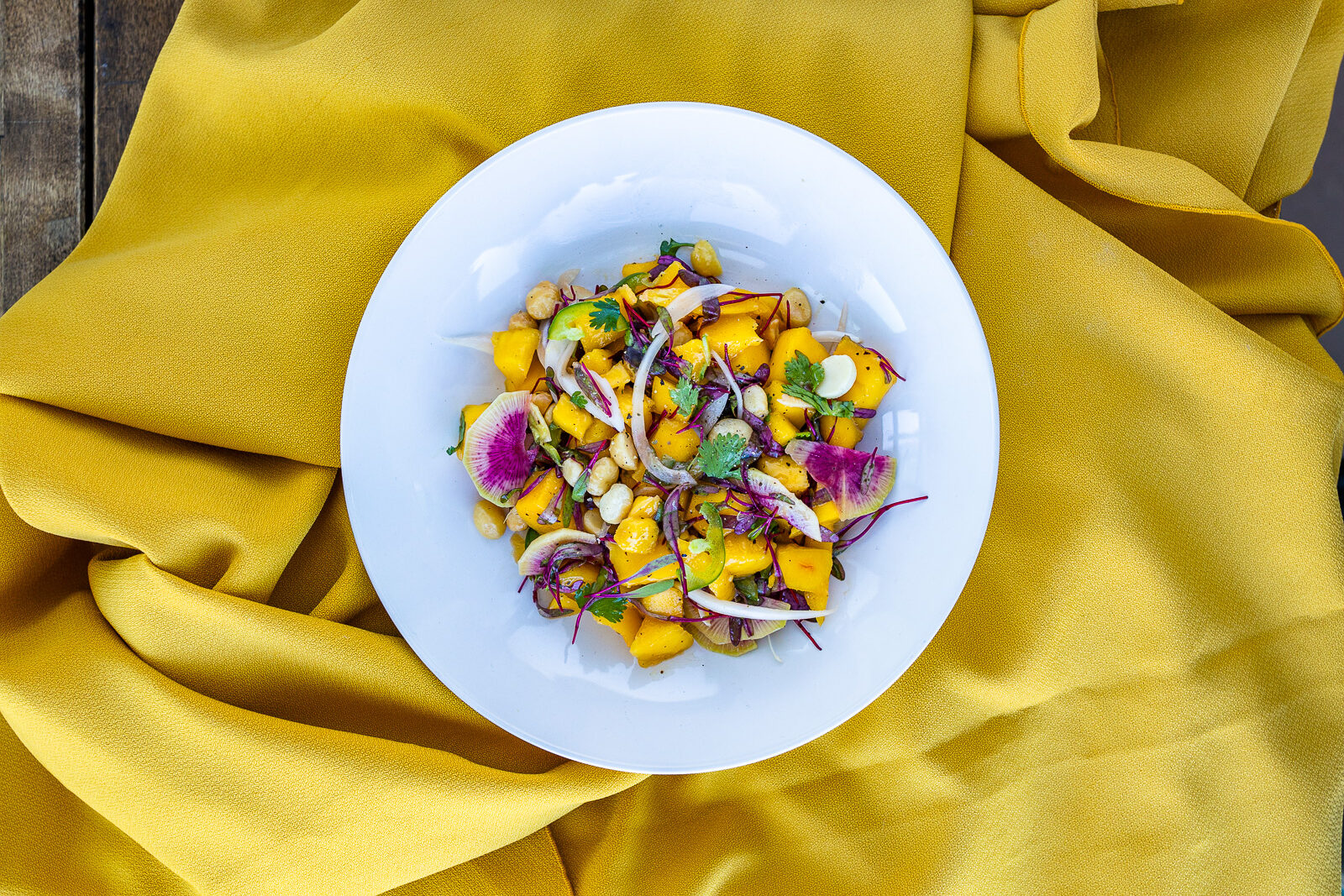 Mango Salad with Watermelon, Daikon and Cilantro Mango Salad with watermelon, daikon and cilantro in a bowl on a yellow tablecloth