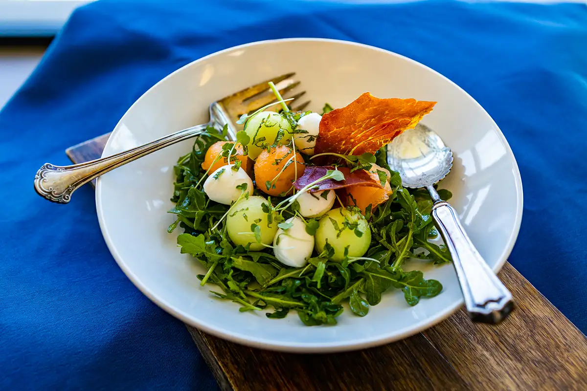 melon-arugula-salad-prosciutto A melon and arugula salad with crispy prosciutto.