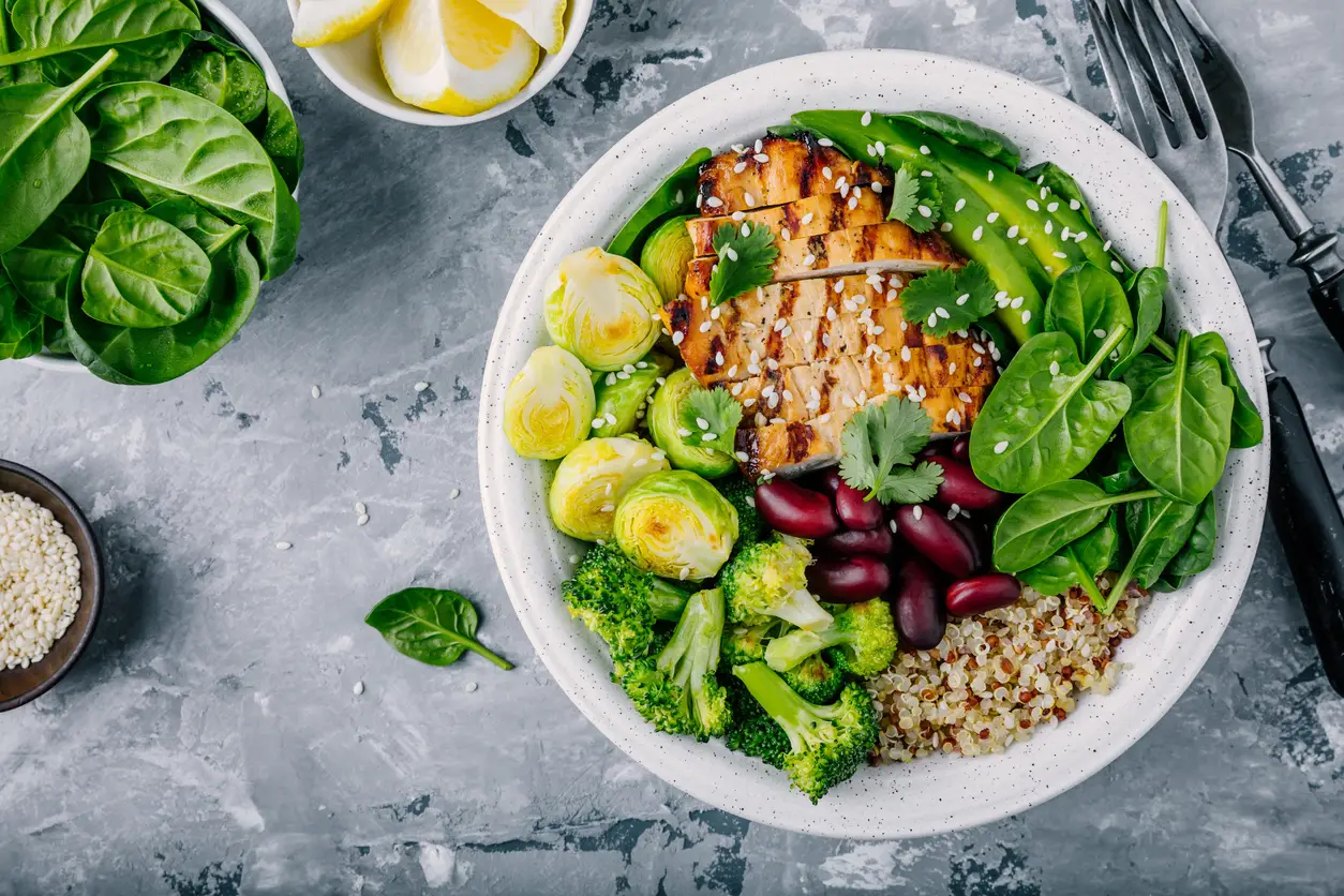 A nourishing bowl of greens, quinoa, veggies and chicken.